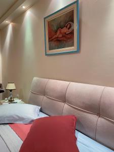 a bedroom with a couch and a painting on the wall at Pendeli's Luxury in Athens