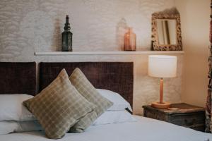 a bedroom with a bed with two pillows and a lamp at Inn in the Park in Bournemouth