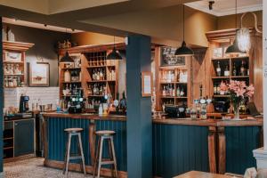 a bar with two stools in a room at Inn in the Park in Bournemouth