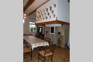 a dining room with a table and a stone fireplace at Landhaus Holthausen in Werne an der Lippe