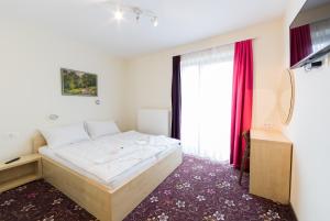 Voodi või voodid majutusasutuse Hotel Jakec Trije kralji na Pohorju toas