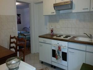 a kitchen with a sink and a stove top oven at Gästehaus 22 - Appartementhaus in Baden-Baden