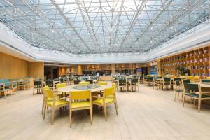 a library with tables and chairs and books at Holiday Inn Express Shanghai Songjiang Fangta by IHG in Songjiang