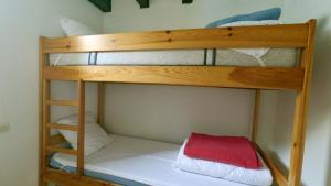 two bunk beds in a small room with a red box at Chalets "les gentianes" in Sorgeat