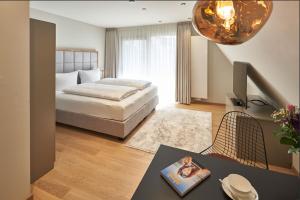 a bedroom with a bed and a table with a book at Kaiser 4 in Norderney