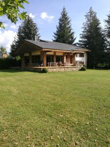 a house with a large grass field in front of it at Casa Etna in Rascafría