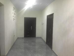 una habitación vacía con dos puertas negras. en 1 Bedroom Apartment in a Prime area, en Accra