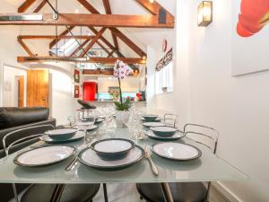 a dining room table with chairs and plates on it at 4 Holt Court in Salisbury