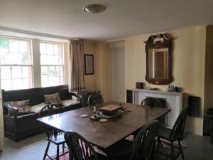 a living room with a table and a couch at Beautiful 8-Bed House in Angus in Kirriemuir