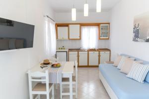 a living room filled with furniture and a window at Acrothea Suites and Villas in Akrotiri