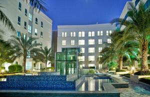 a rendering of a hotel with a pool and palm trees at Millennium Executive Apartments Muscat in Muscat