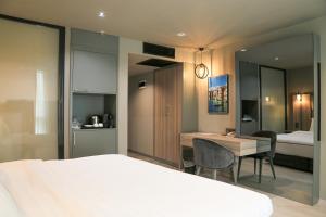 een hotelkamer met een bed, een bureau en een slaapkamer bij Pasaport Pier Hotel in Izmir
