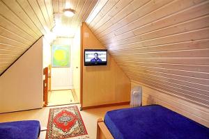 a room with two beds and a tv on a wall at Modern Apartment in Westerland-Sylt, 50 sqm, close to beaches in Westerland (Sylt)