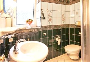 a bathroom with a sink and a toilet at Modern Apartment in Westerland-Sylt, 50 sqm, close to beaches in Westerland (Sylt)