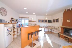 a kitchen with a counter and a living room at Penzión Belvia in Nová Lesná