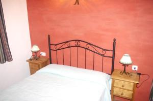 a bedroom with a bed and two night stands at Charming House with Pool in El Borge in Borge +12 photos