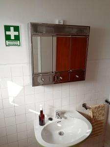 a bathroom with a sink and a mirror at Casa das Flores in Santo Tirso +18 photos