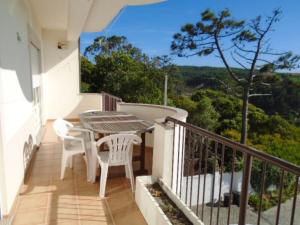 a balcony with a table and chairs and a view at 2 bedrooms villa at Pataias 700 m away from the beach with sea view private pool and enclosed garden in Pataias