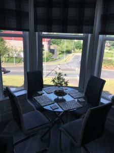a table and chairs in a room with a window at Lovely 2- Bed Apartment in Hawick in Hawick