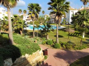ミハス・コスタにある2 bedrooms appartement with shared pool and wifi at Cala de Mijas 3 km away from the beachのヤシの木が植わるリゾートです。