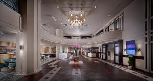 a lobby of a hotel with a chandelier at Crowne Plaza Athens City Centre, an IHG Hotel in Athens