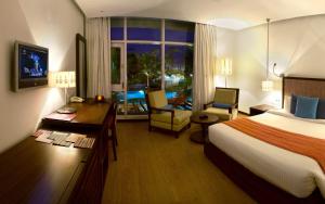 a hotel room with a bed and a desk and a room at The Park Visakhapatnam in Visakhapatnam