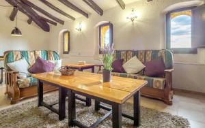 a living room with couches and a wooden table at Spacious House in Can Trabal in Can Trabal