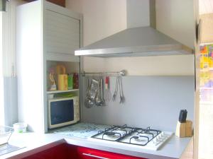 a kitchen with a stove top in a kitchen at Maison confortable à Lunas avec vue montagne + jardin in Lunas