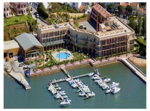 an aerial view of a hotel with boats in a marina at Charming Apartment in Estômbar with Private Pool. in Estômbar