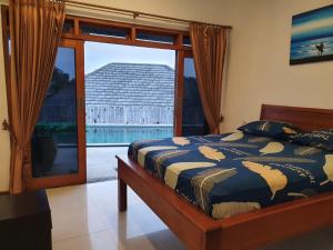 Postel nebo postele na pokoji v ubytování Surf Bali Villa