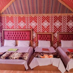 A bed or beds in a room at Wadi Rum Dream Camp