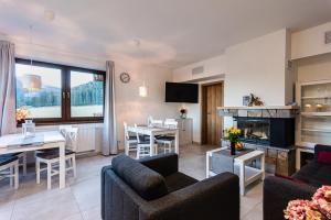 a living room with a couch and a dining room at Tatry Panorama in Pavčina Lehota