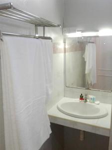 a bathroom with a white sink and a mirror at Modern Studio with Pool in Grand Baie - 40 sqm - A/C. in Grand Baie