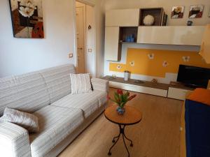a living room with a white couch and a table at Casa Nilva Holiday in Sanremo in Sanremo