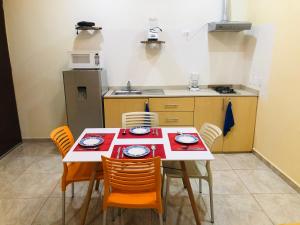 a dining room table and chairs in a kitchen at Hotel Arcoiris Tulum in Tulum