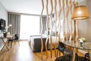 a hotel room with a bed and a table at CasaSur Bellini in Buenos Aires