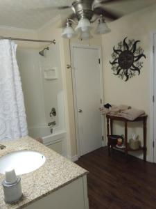 a bathroom with a sink and a mirror at serenity hill bed and breakfast in Sloans Crossing