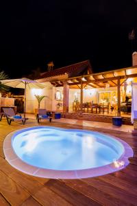 a large pool on a wooden deck at night at Villa Centrum Corralejo Beach private pool free wiffi in Corralejo