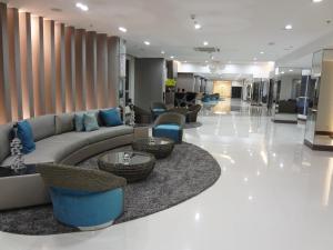 a lobby with a couch and tables and chairs at manila sea view homes 21 in Manila