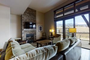 a living room with a couch and a fireplace at Trailhead Lodge 4100 in Steamboat Springs