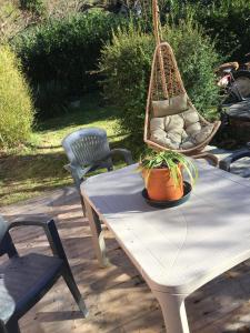 a picnic table with a hanging hammock on it at Il Ghiretto Appartamento in Riccò del Golfo di Spezia