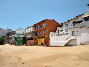 a group of buildings on the side of a beach at Casa do Mar in Guarapari