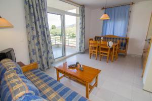 a living room with a couch and a table at Agi Rescator Apartments in Roses