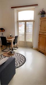 a living room with a large window and a table at Studio Terrasse Spa in Spa