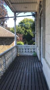a porch of a house with a white fence at Studio Terrasse Spa in Spa