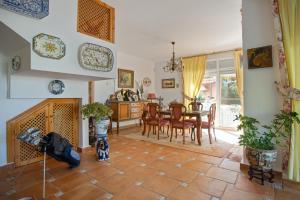 a kitchen and dining room with a table and chairs at 4 bedrooms villa with sea view private pool and furnished terrace at Sanlucar de Barrameda 2 km away from the beach in Sanlúcar de Barrameda