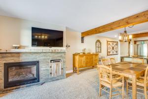 a living room with a fireplace and a table with chairs at Butte Basecamp in Crested Butte