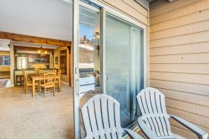 two white chairs sitting on a porch with a table at Butte Basecamp in Crested Butte