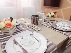 a table with white plates and flowers on it at Royal Dreams in Caserta