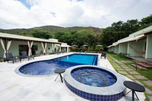 a swimming pool in the middle of a resort at Pousada Cantuá in Serra do Cipo